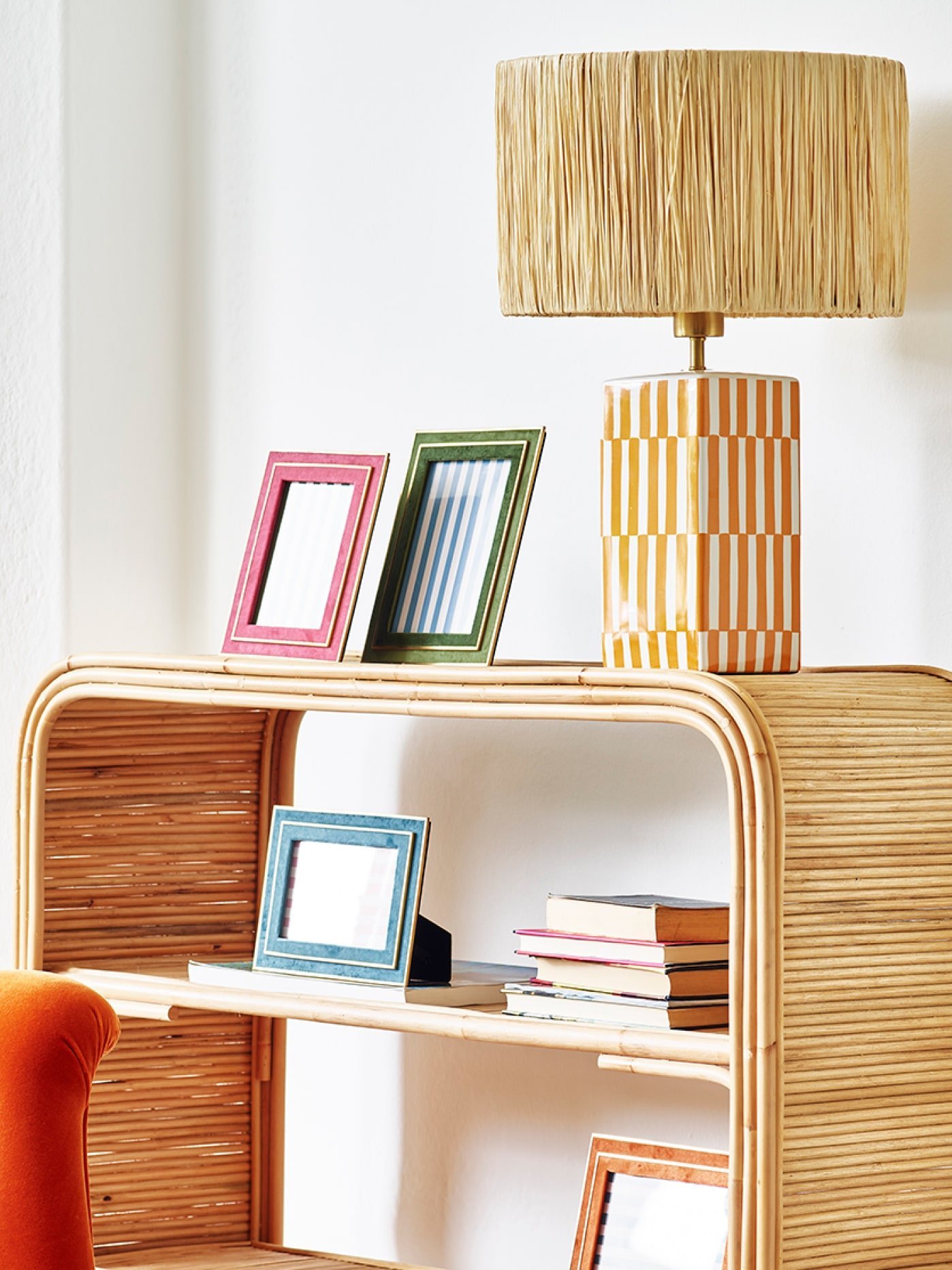 Photo frames and a lamp on book shelves