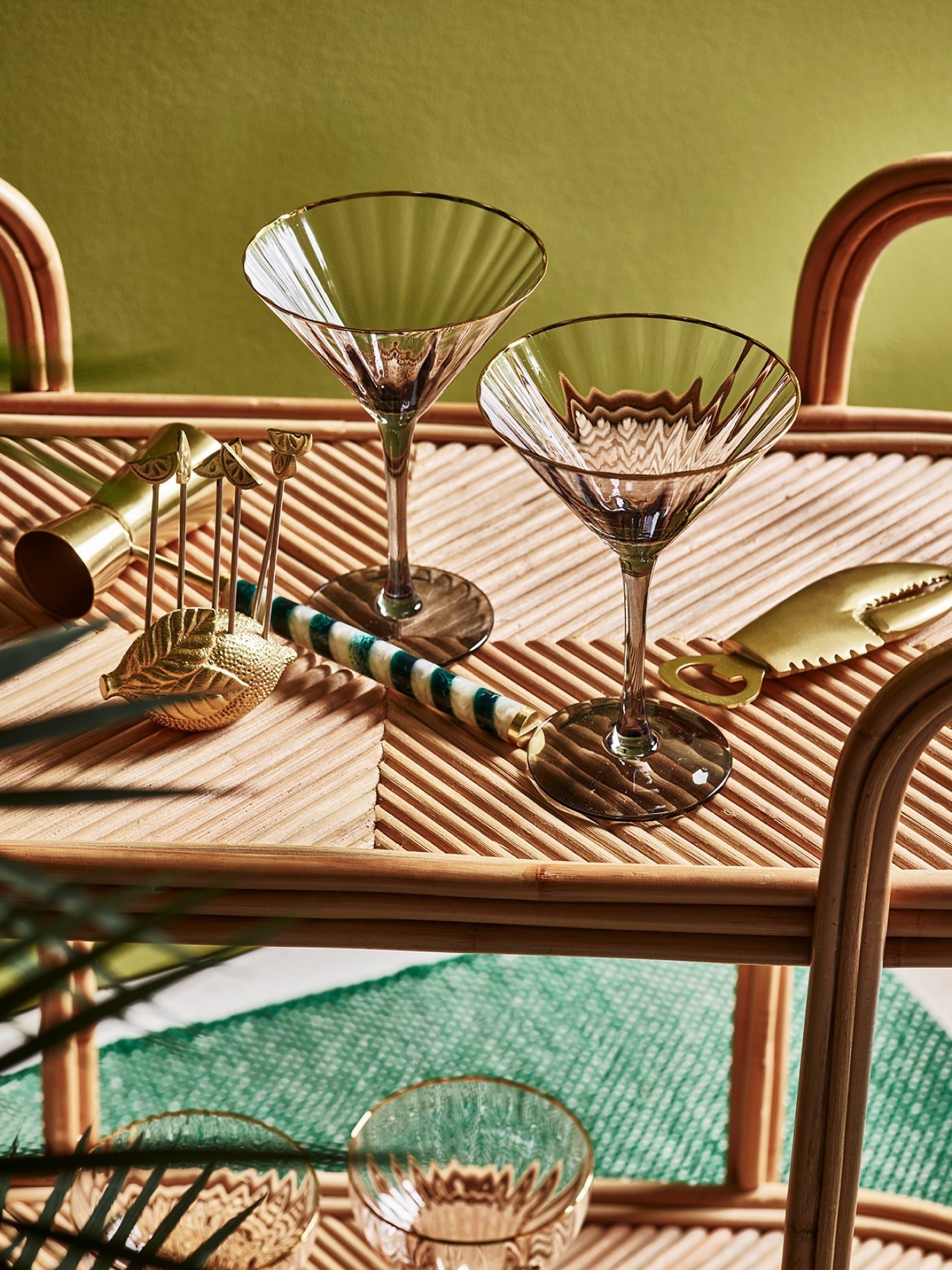 Cocktail glasses and barware on a bar cart